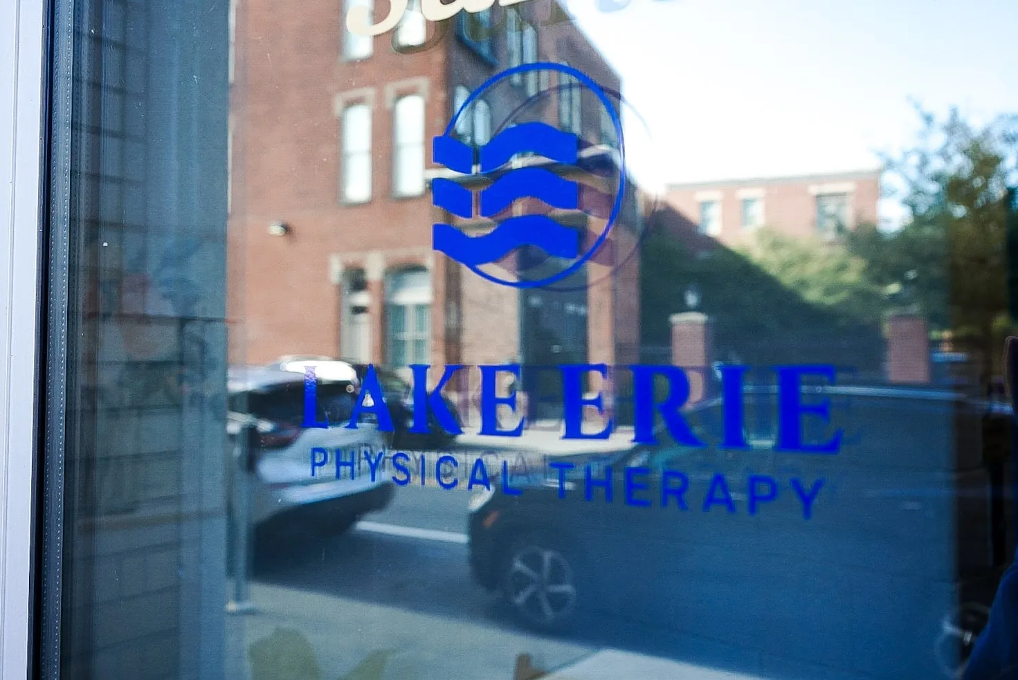 Lake Erie Physical Therapy logo on the clinic's front window on Virginia Street